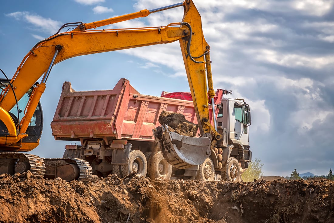 Excavator and Dump Truck at Construction Site